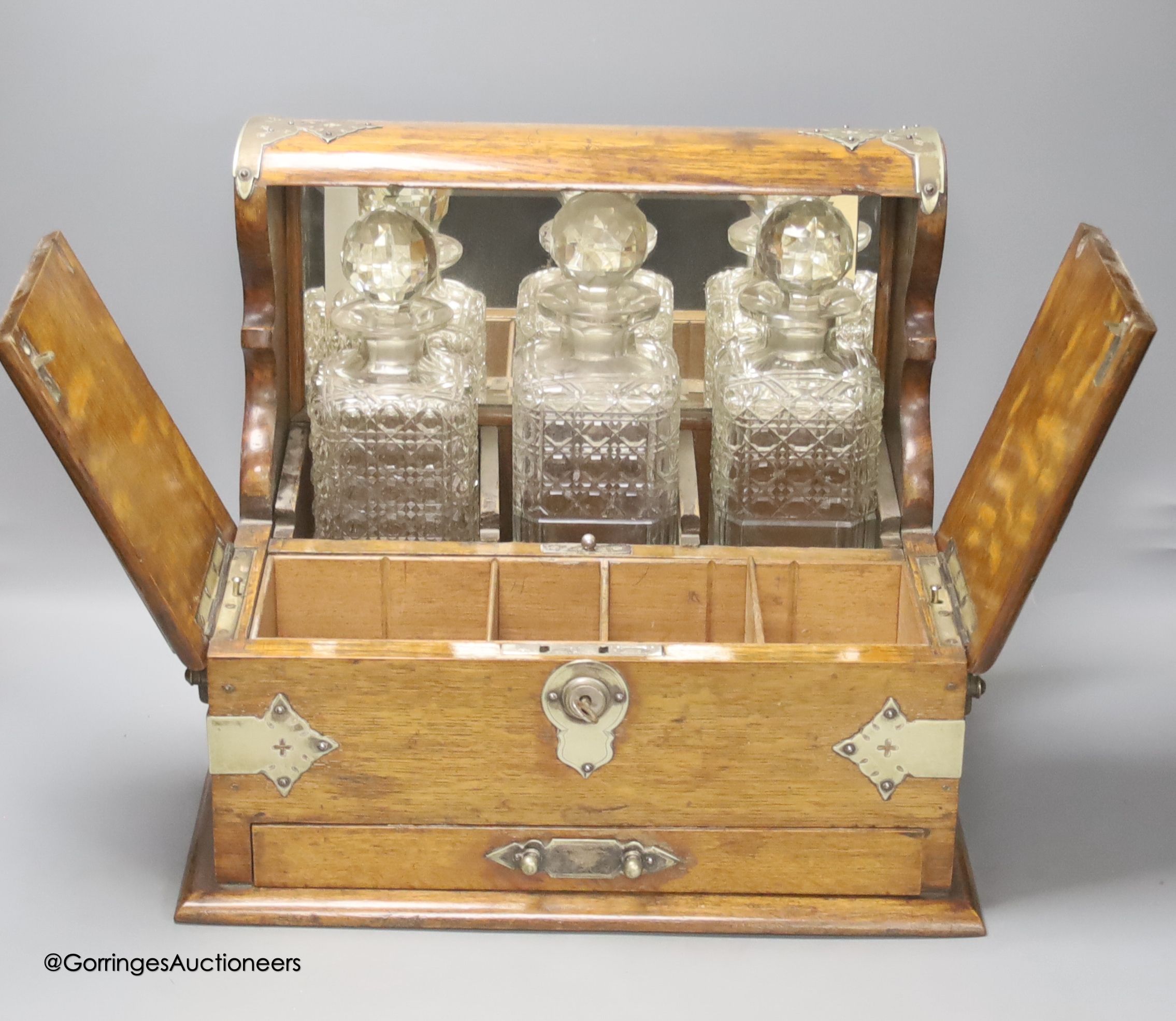 A Victorian oak tantalus and games compendium, height 33cm depth 29cm width 38cm